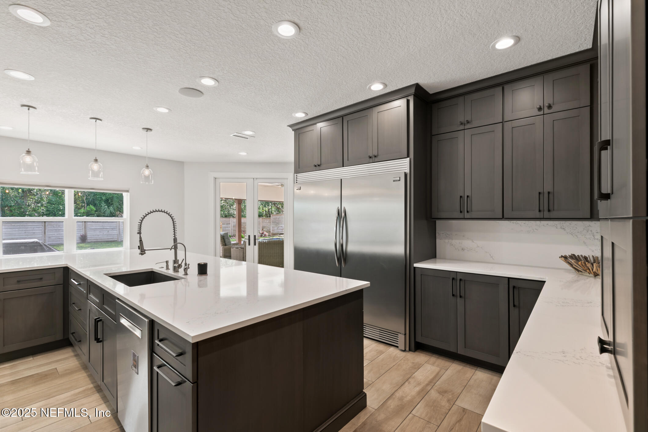 2341 Fiddlers Lane Atlantic Beach, FL 32233 - Photo 16 of 87 a kitchen with kitchen island a sink stainless steel appliances and cabinets