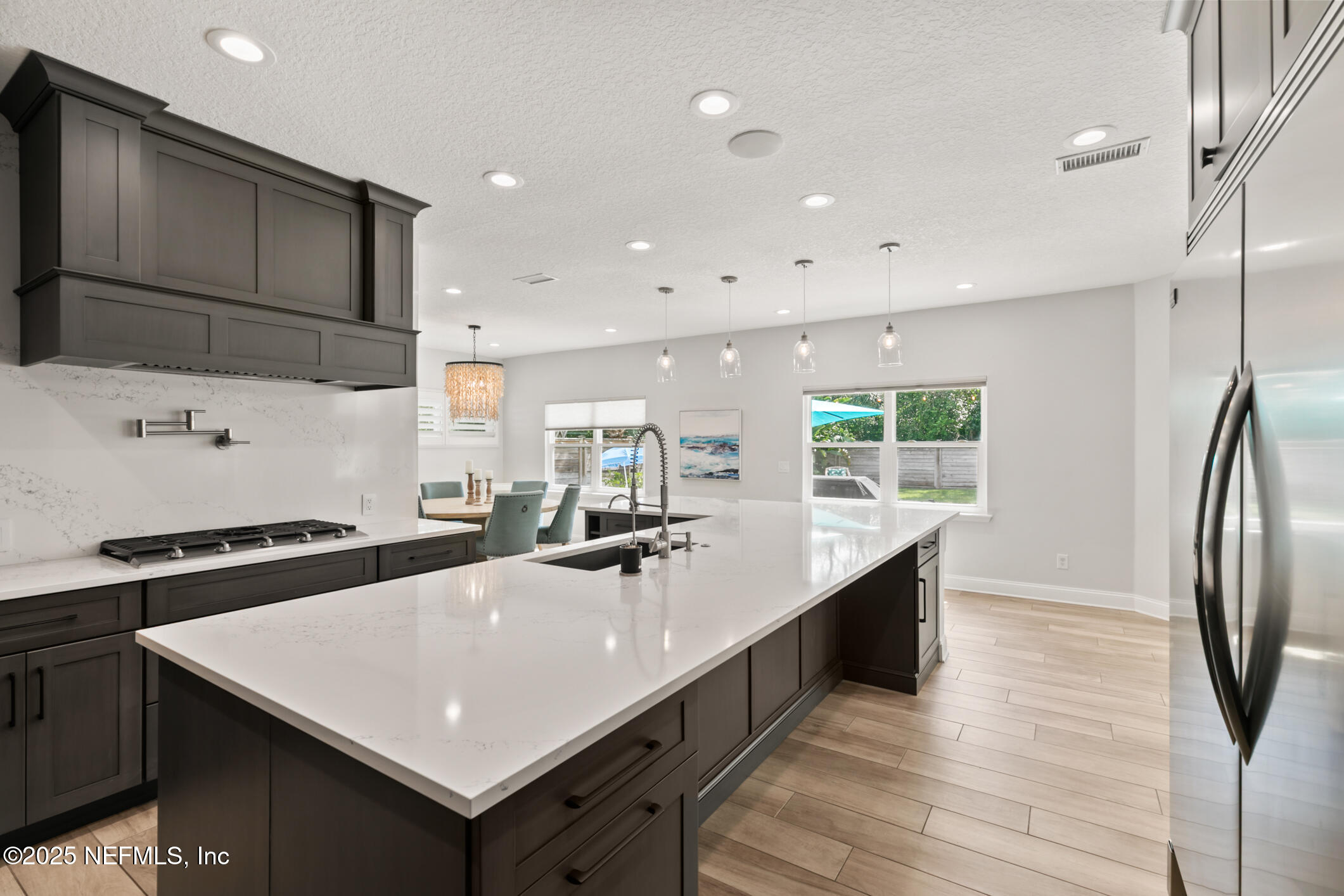 2341 Fiddlers Lane Atlantic Beach, FL 32233 - Photo 17 of 87 a kitchen with stainless steel appliances a sink a stove a refrigerator and cabinets
