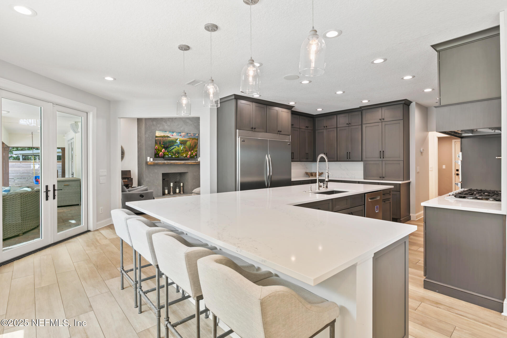 2341 Fiddlers Lane Atlantic Beach, FL 32233 - Photo 21 of 87 a kitchen with stainless steel appliances kitchen island granite countertop a refrigerator a sink a stove a dining table and chairs