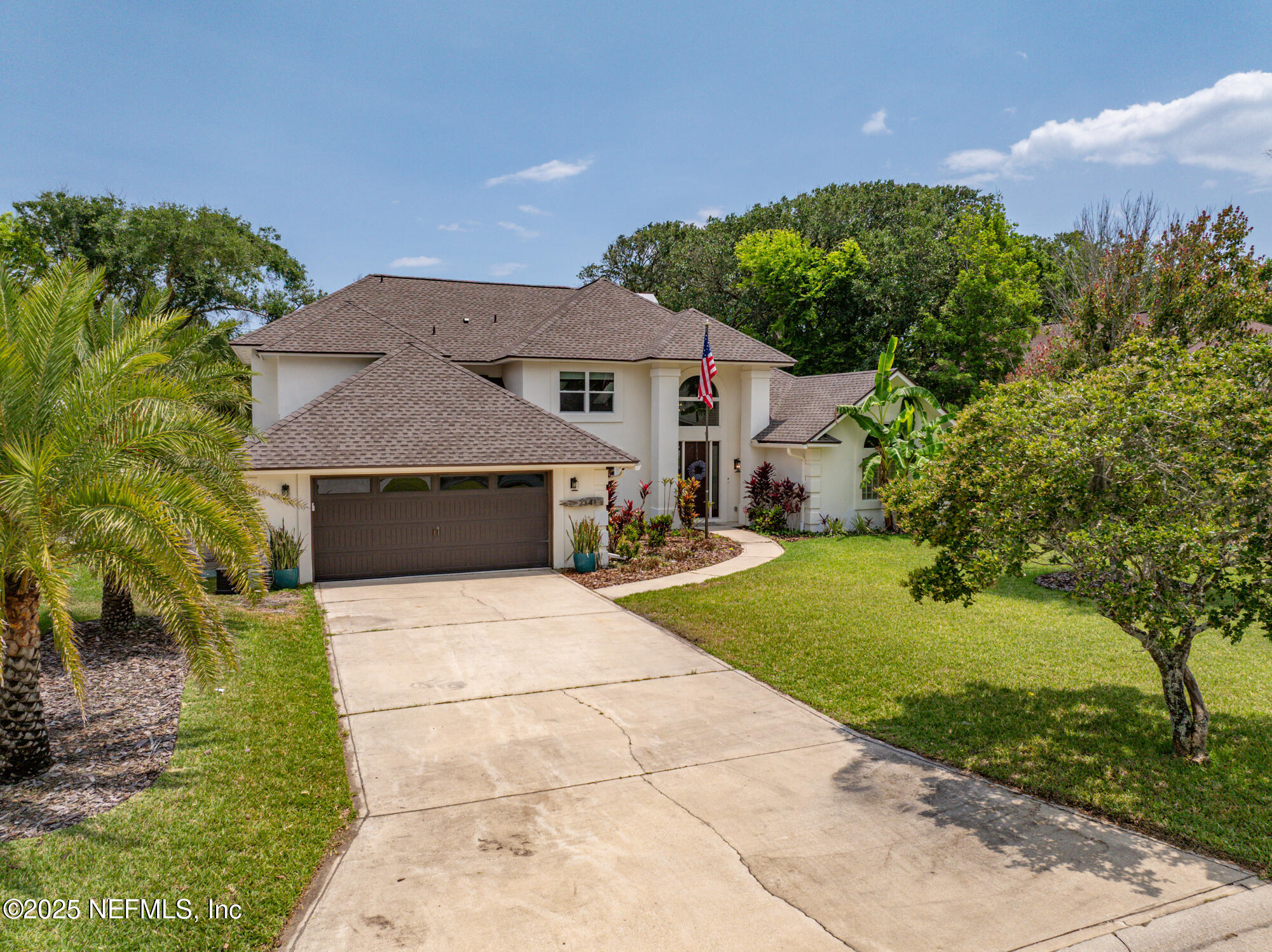 2341 Fiddlers Lane Atlantic Beach, FL 32233 - Photo 3 of 87 a front view of a house with a yard and garage