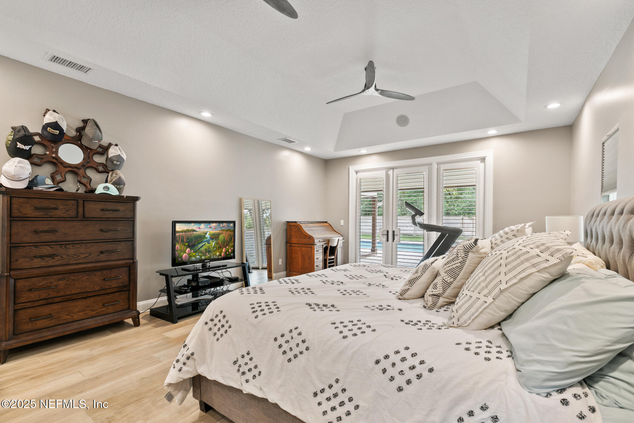 2341 Fiddlers Lane Atlantic Beach, FL 32233 - Photo 33 of 87 a large bedroom with a bed a dresser and flat screen tv