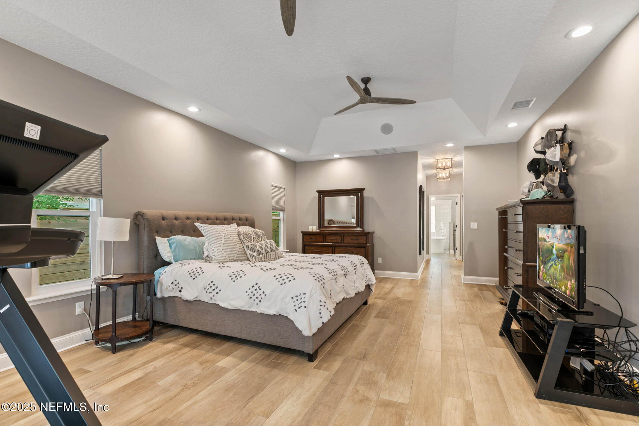 2341 Fiddlers Lane Atlantic Beach, FL 32233 - Photo 34 of 87 a bedroom with a bed a mirror on dresser and a wooden floor