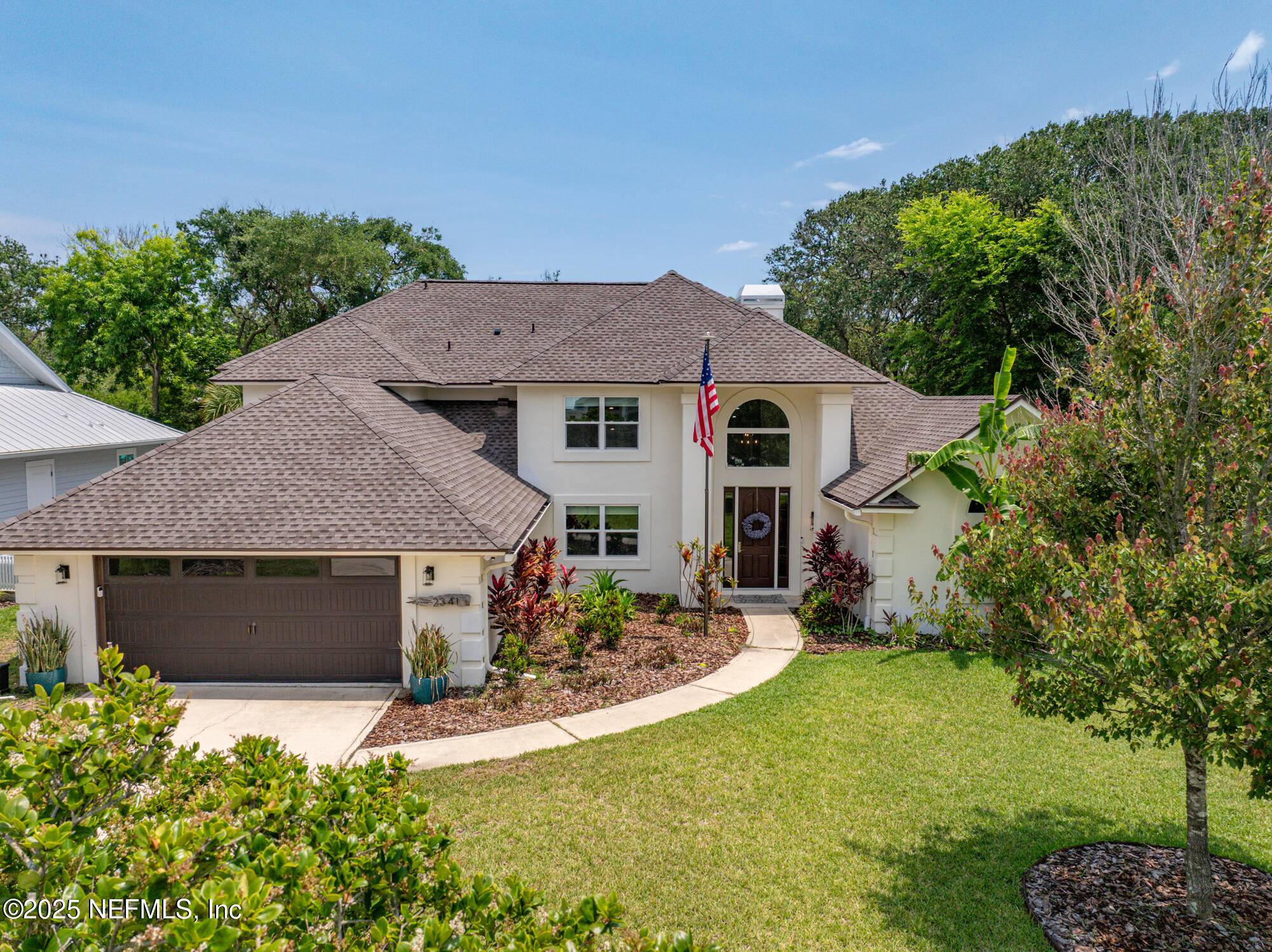 2341 Fiddlers Lane Atlantic Beach, FL 32233 - Photo 4 of 87 a front view of a house with a yard and garage