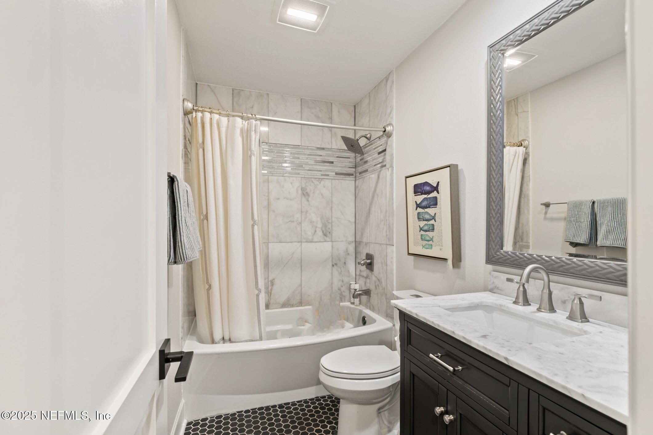 2341 Fiddlers Lane Atlantic Beach, FL 32233 - Photo 49 of 87 a bathroom with a granite countertop sink toilet a mirror and shower