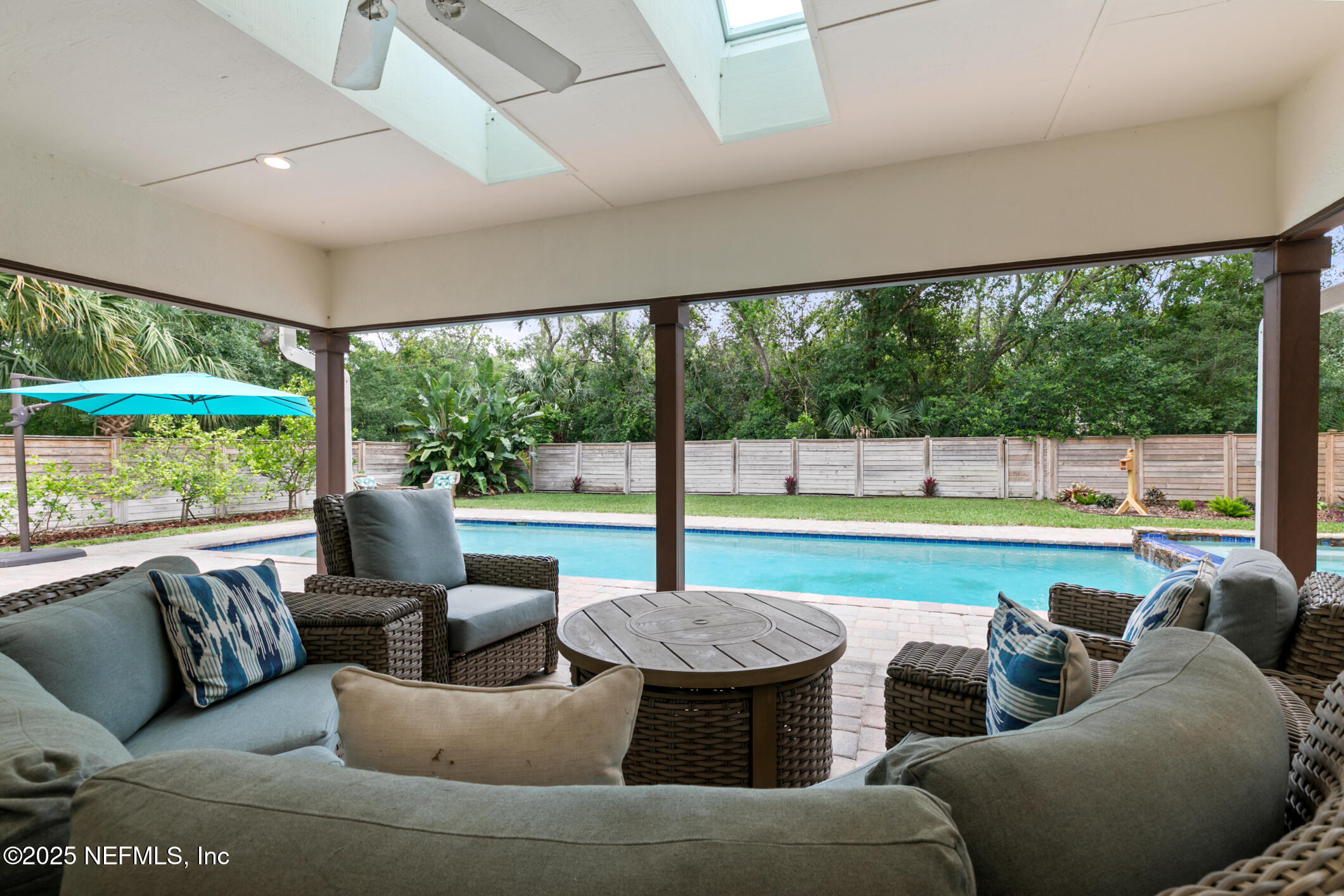 2341 Fiddlers Lane Atlantic Beach, FL 32233 - Photo 65 of 87 a living room with furniture and a floor to ceiling window