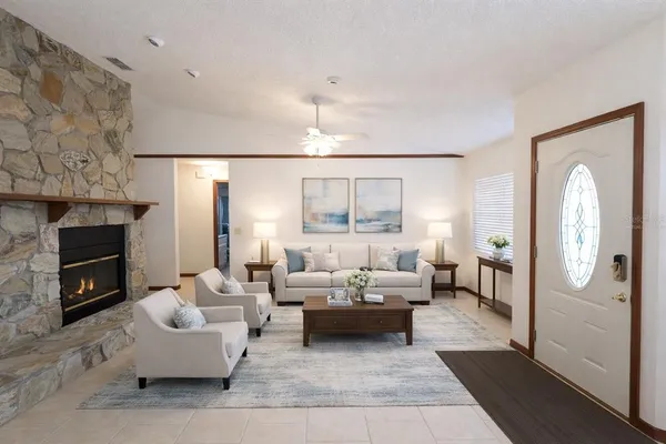 a living room with furniture fireplace and a chandelier