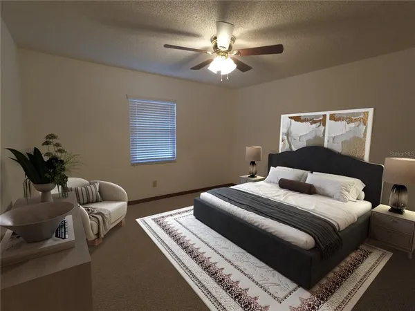a bedroom with a bed and ceiling fan