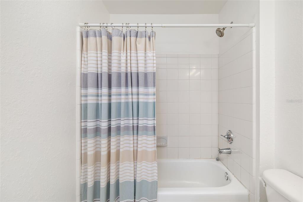 8933 Manor Loop, Unit 205 Lakewood Ranch, FL 34202 - Photo 26 of 76 a bathroom with a bathtub