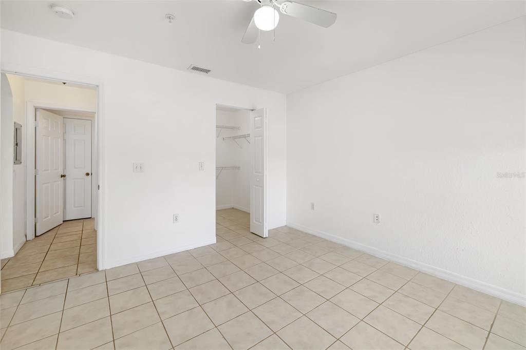 8933 Manor Loop, Unit 205 Lakewood Ranch, FL 34202 - Photo 28 of 76 an empty room with white walls and tiles