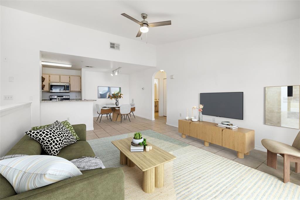 8933 Manor Loop, Unit 205 Lakewood Ranch, FL 34202 - Photo 6 of 76 a living room with furniture and a flat screen tv