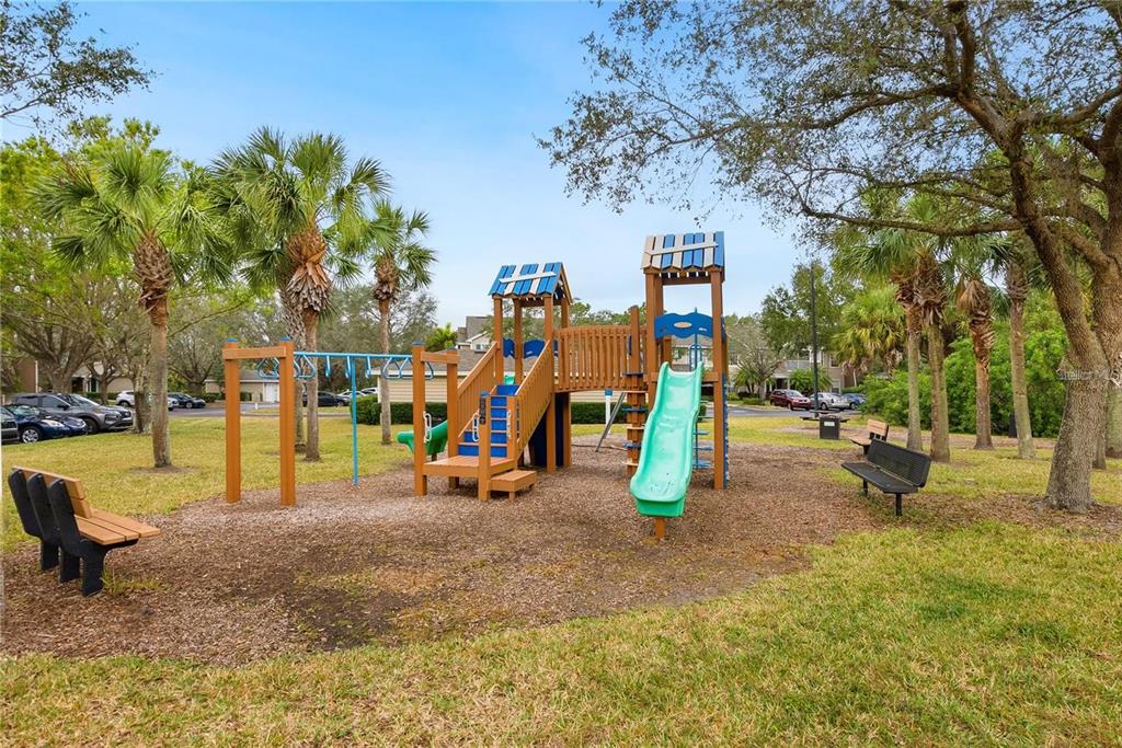 8933 Manor Loop, Unit 205 Lakewood Ranch, FL 34202 - Photo 64 of 76 a view of a park with swings and slides