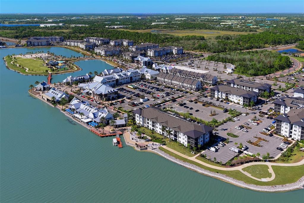 8933 Manor Loop, Unit 205 Lakewood Ranch, FL 34202 - Photo 71 of 76 an aerial view of lake and residential houses with outdoor space