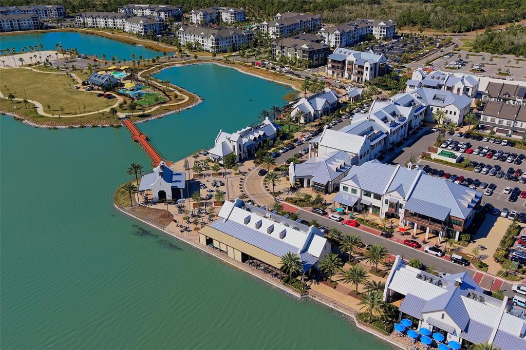 8933 Manor Loop, Unit 205 Lakewood Ranch, FL 34202 - Photo 73 of 76 an aerial view of a house with a swimming pool outdoor seating and yard