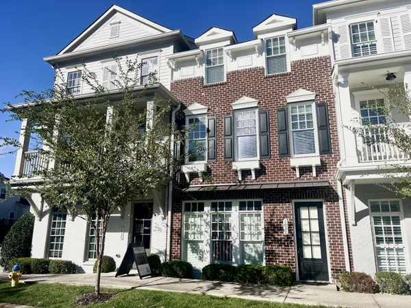 a front view of a residential apartment building with a yard