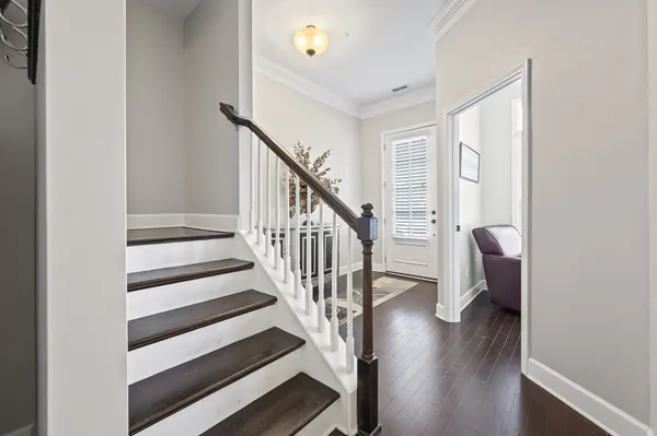 a view of entryway with wooden floor and stairs