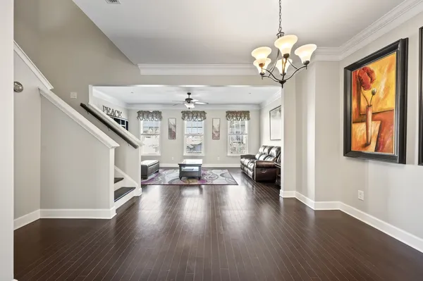 a view of a livingroom with furniture wooden floor chandelier