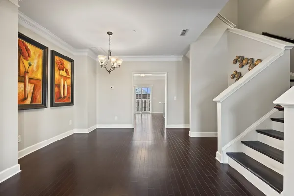 a view of an entryway with wooden floor and stairs