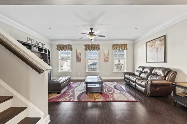 a living room with furniture and a chandelier