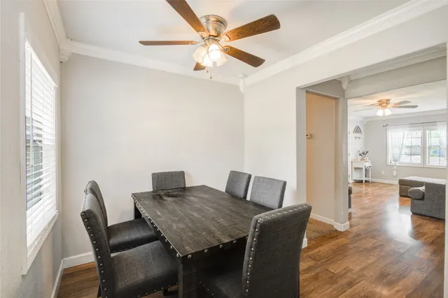 a view of a dining room with furniture and wooden floor
