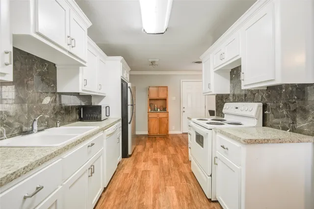 a large kitchen with a stove top oven