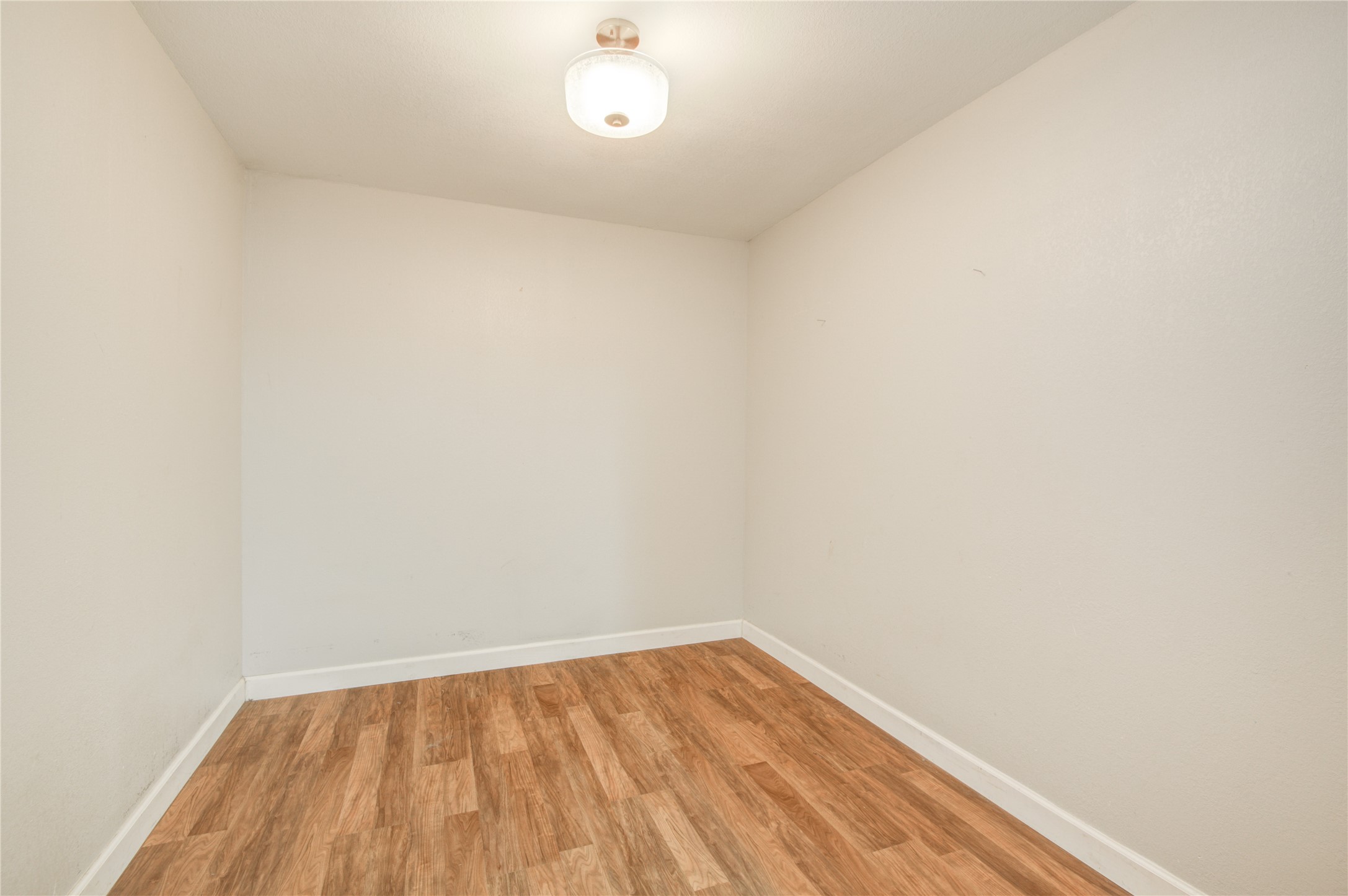 513 Farrer Street Angleton, TX 77515 - Photo 18 of 32 a view of empty room with wooden floor