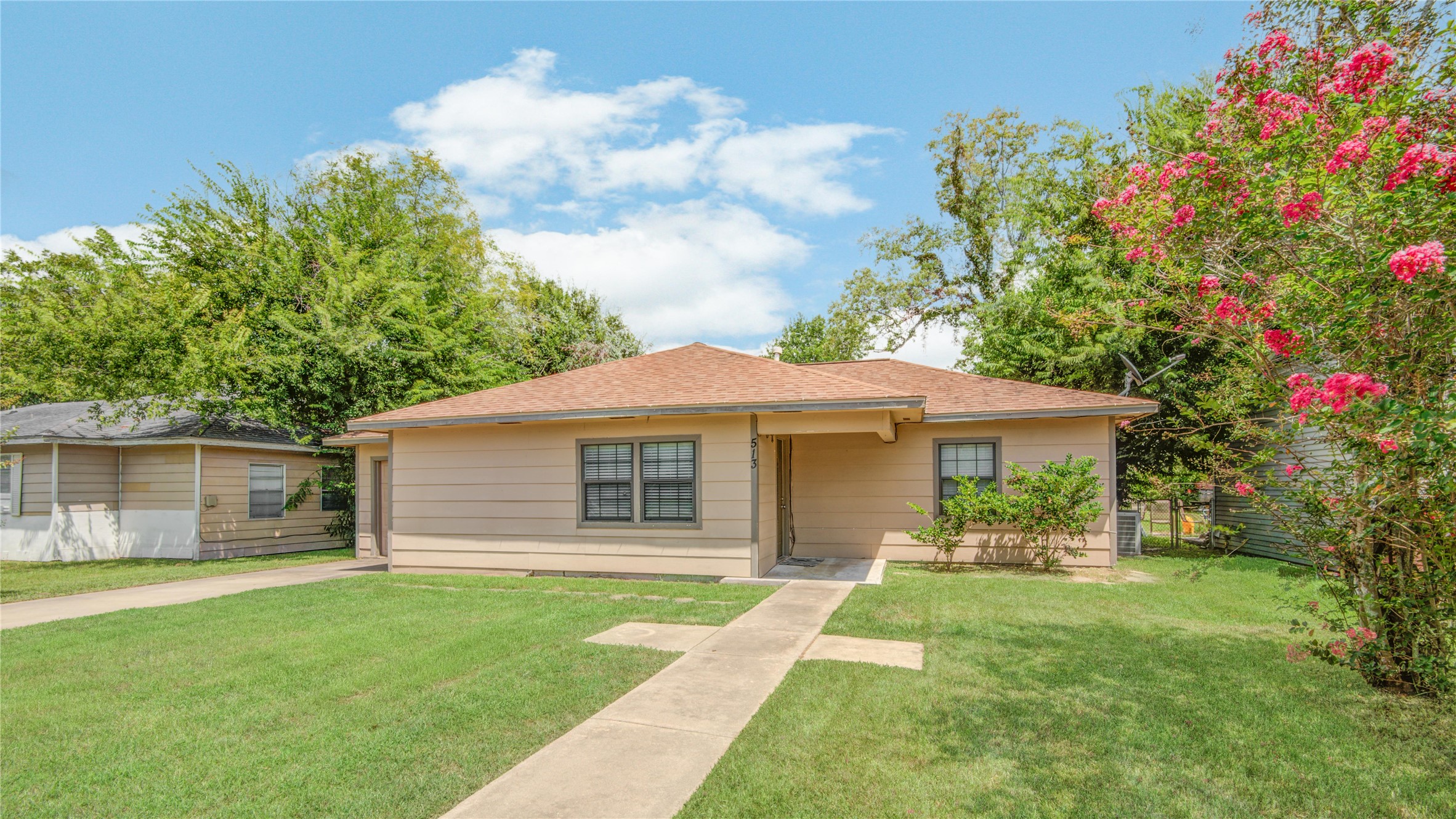 513 Farrer Street Angleton, TX 77515 - Photo 2 of 32 a front view of a house with a garden