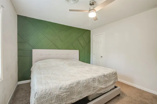 a bedroom with a bed and ceiling fan