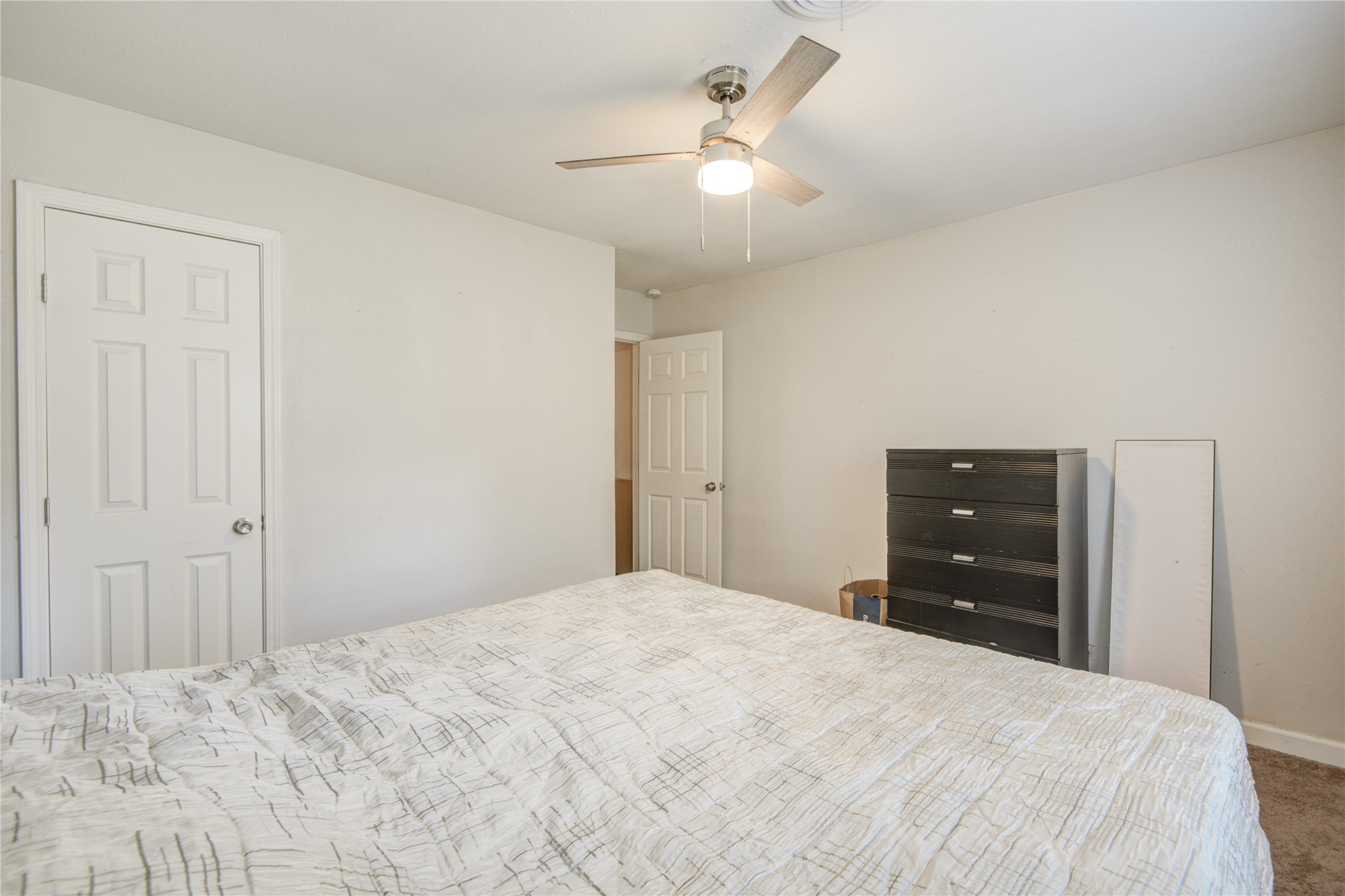 513 Farrer Street Angleton, TX 77515 - Photo 26 of 32 a bedroom with a bed and a dresser