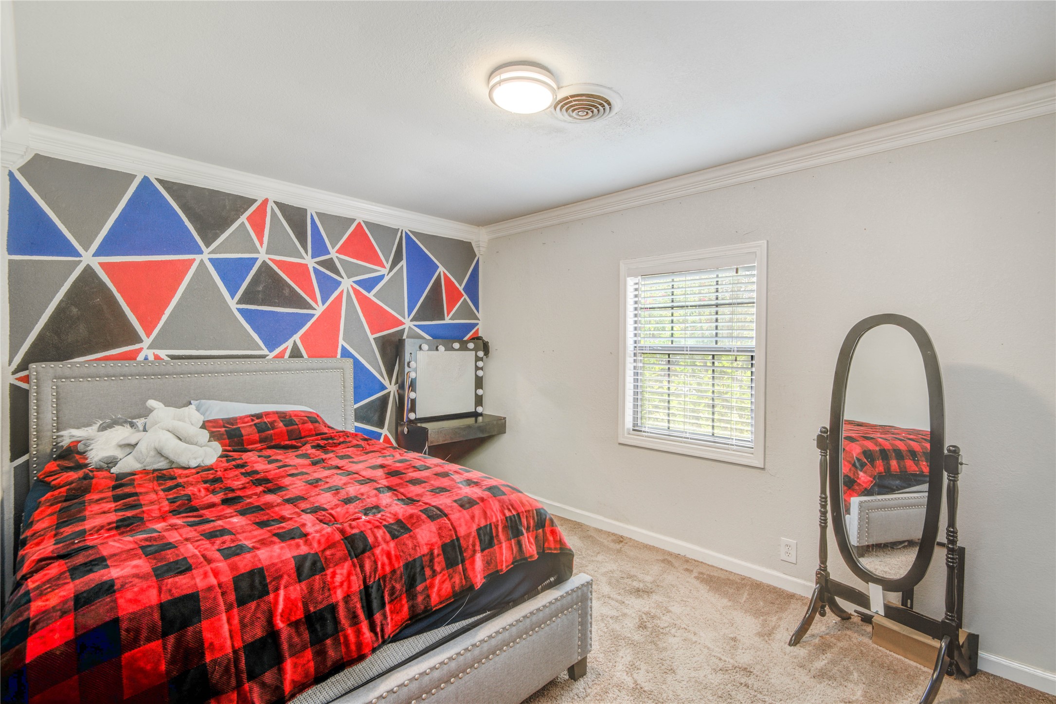 513 Farrer Street Angleton, TX 77515 - Photo 27 of 32 a bedroom with a bed and a bookshelf next to a window