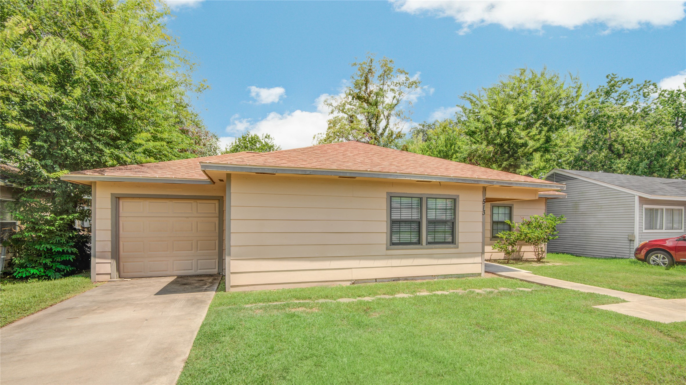 513 Farrer Street Angleton, TX 77515 - Photo 3 of 32 a backyard of a house with potted plants and large tree
