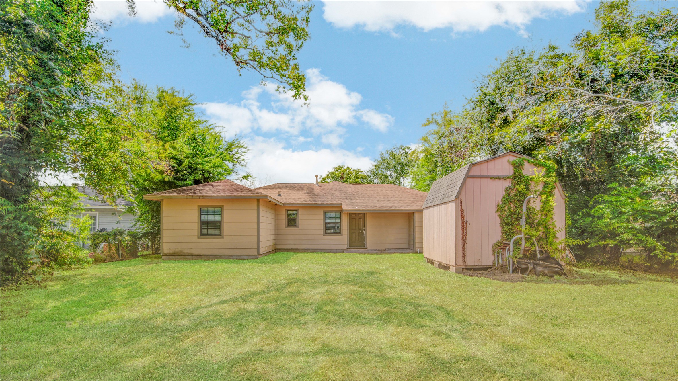 513 Farrer Street Angleton, TX 77515 - Photo 32 of 32 a view of a house with a backyard