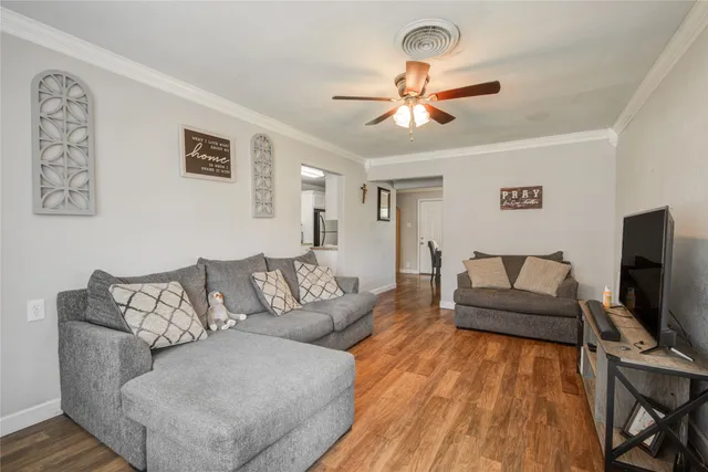 a living room with furniture and a flat screen tv