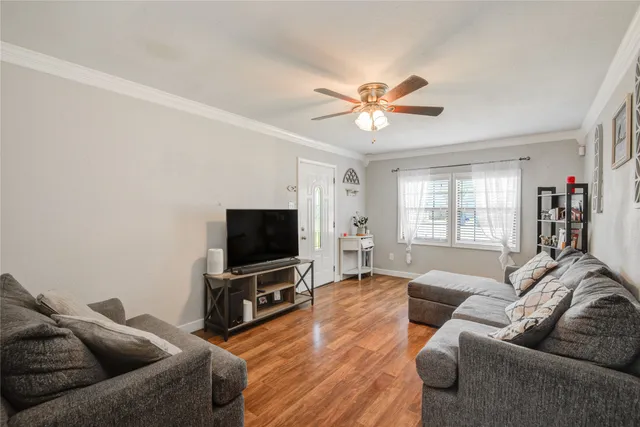 a living room with furniture and a flat screen tv