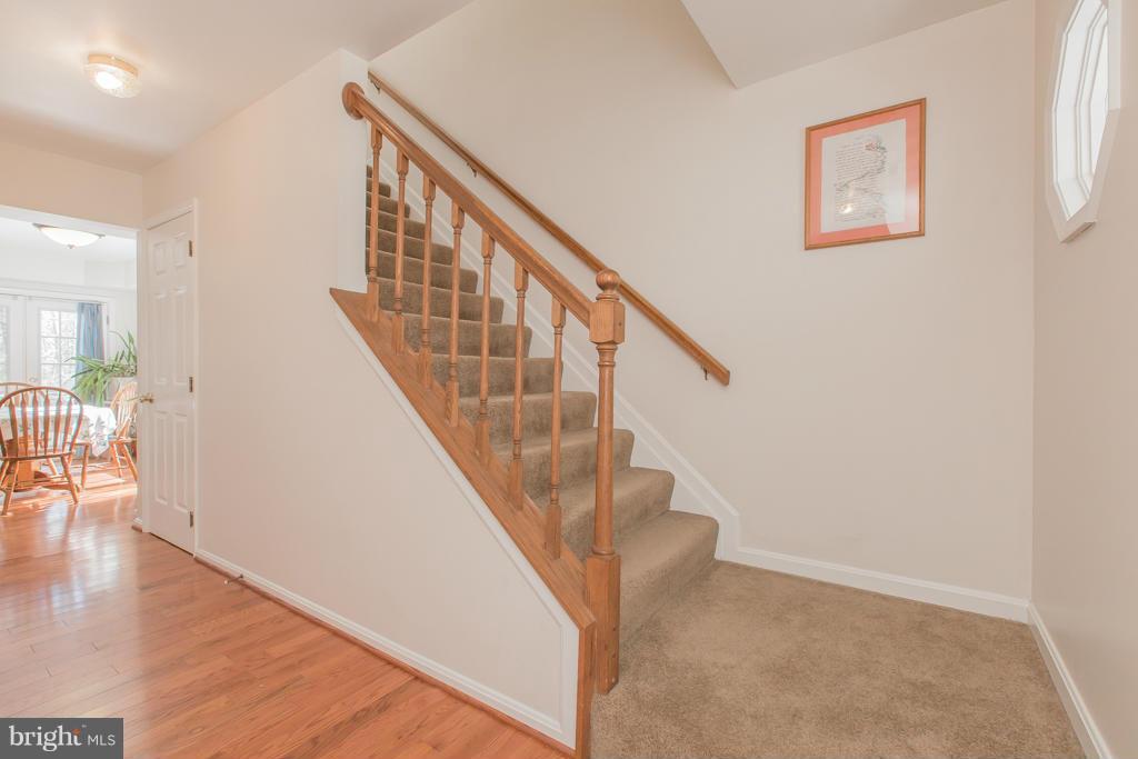 11360 Commanche Road Lusby, MD 20657 - Photo 14 of 29 a view of entryway and hall with wooden floor