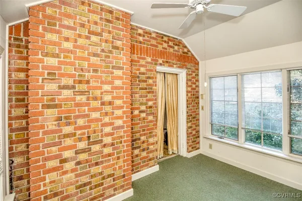 a view of an empty room with window and stairs