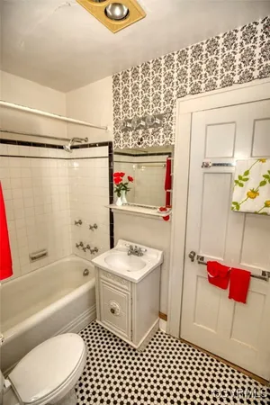 a bathroom with a toilet a sink and a shower