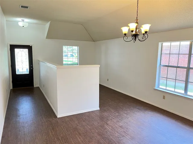 a view of a room with wooden floor and windows