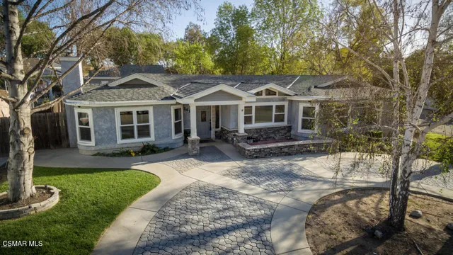 a front view of a house with a yard table and chairs