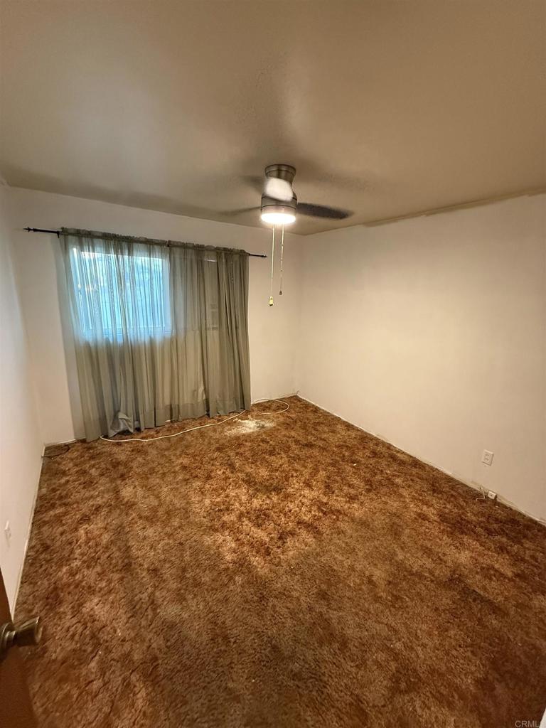 2220 Rachael Avenue National City, CA 91950 - Photo 15 of 26 an empty room with a chandelier fan and windows