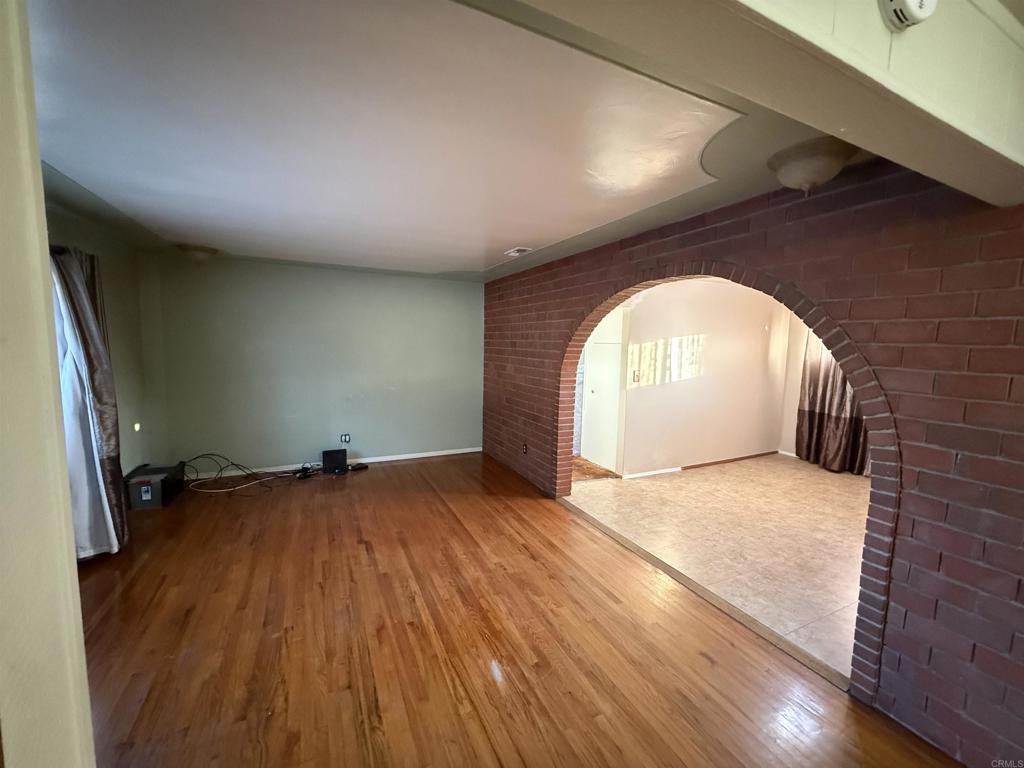 2220 Rachael Avenue National City, CA 91950 - Photo 4 of 26 an empty room with wooden floor and a window