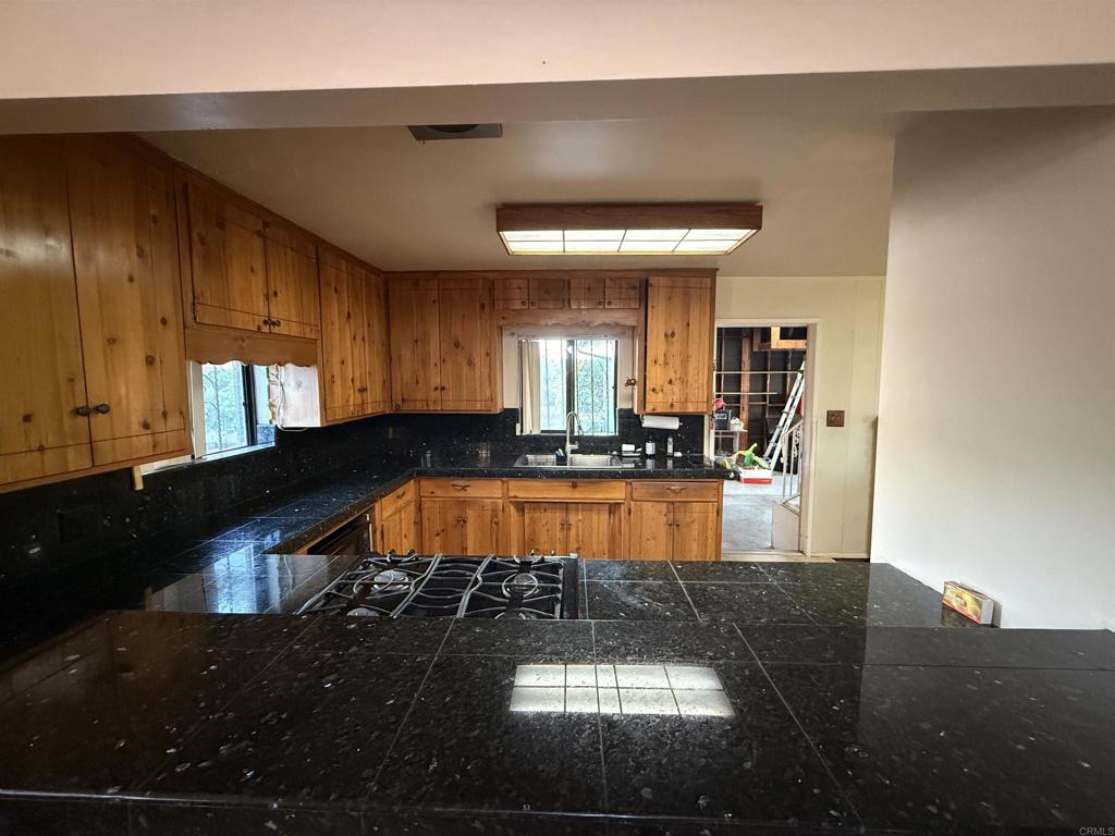 2220 Rachael Avenue National City, CA 91950 - Photo 9 of 26 a living room with a fireplace furniture and a kitchen view