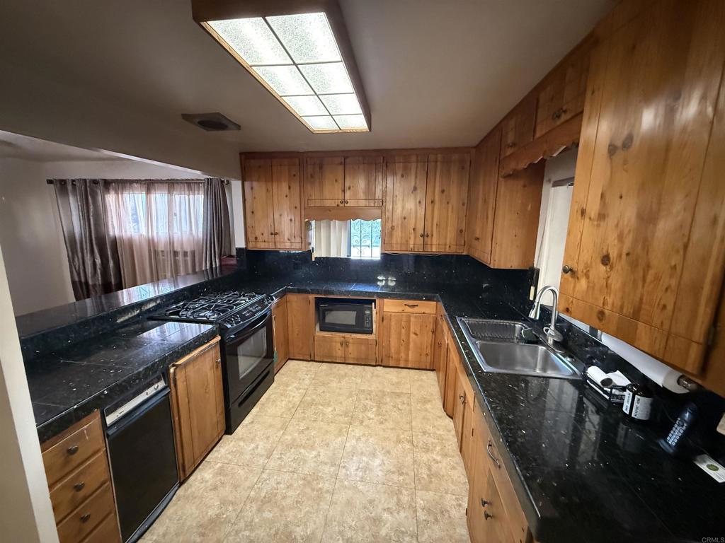 2220 Rachael Avenue National City, CA 91950 - Photo 10 of 26 a kitchen with granite countertop a stove a sink and a refrigerator