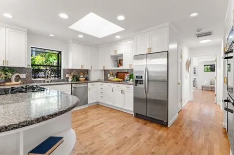 a kitchen with a sink stove and cabinets