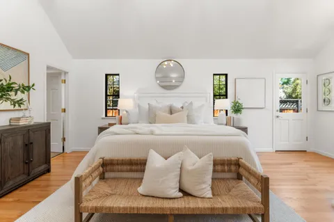 a bedroom with a bed and a painting on the wall