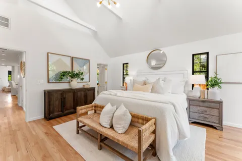 a bedroom with a bed and a table