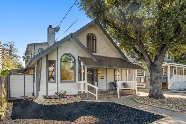 a view of a house with a yard and garage