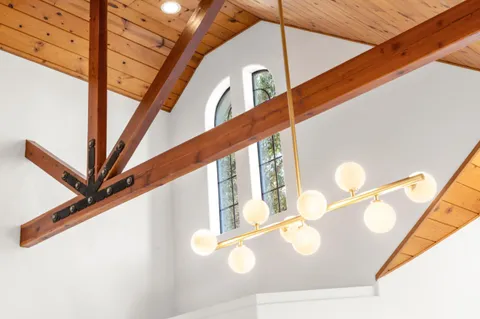 a living room with furniture a chandelier and a table