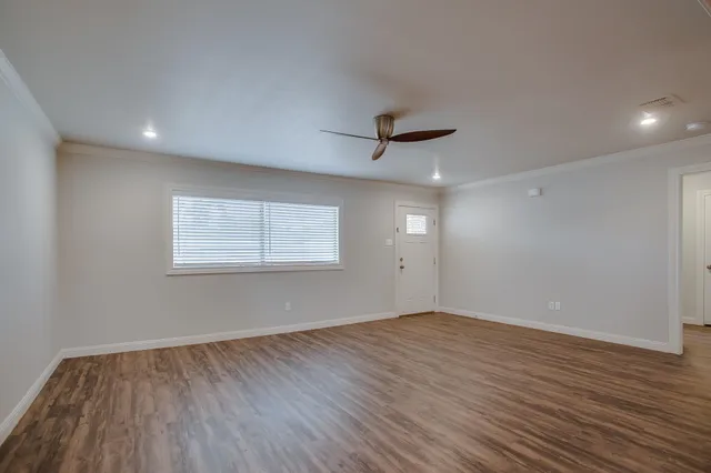 wooden floor in an empty room with a window