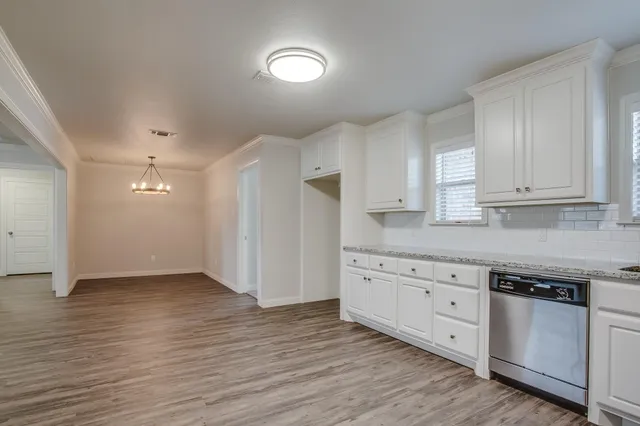 a kitchen with granite countertop a stove and a sink