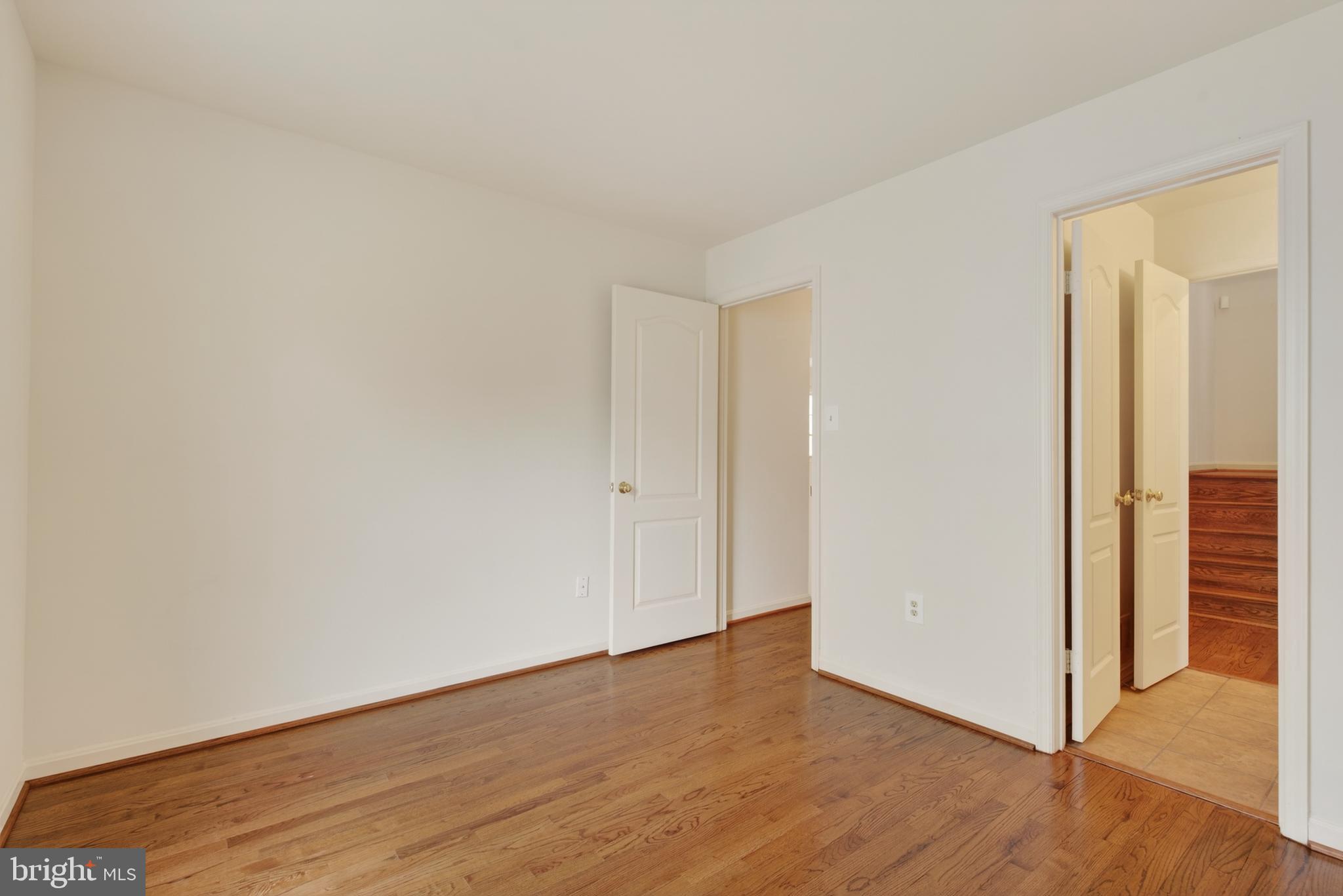 8901 Ellsworth Court Silver Spring, MD 20910 - Photo 34 of 43 a view of an empty room with wooden floor and a window